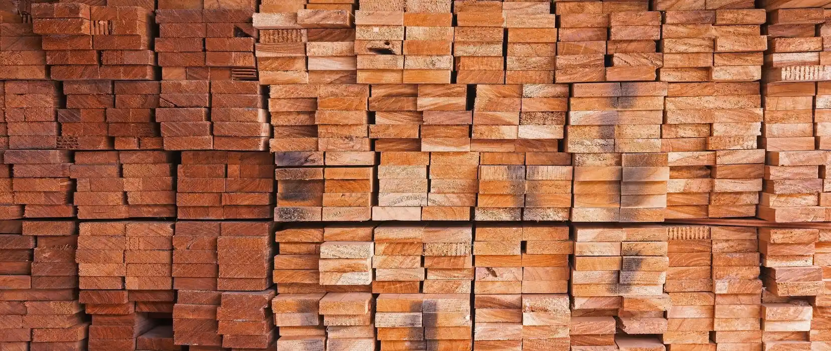 Stacked hardwood boards in the ZANOVA timber store
